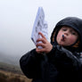 Kid holding up Nature Quest Scavenger Hunt Book by Keep Tassie Wild