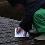 Kid checking off the Nature Quest Scavenger Hunt Book on a bushwalk