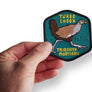 Hand holding the turbo chook patch by Keep Tassie Wild