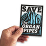 Male hand holding up save the organ pipes bumper sticker to preserve Mt Wellington